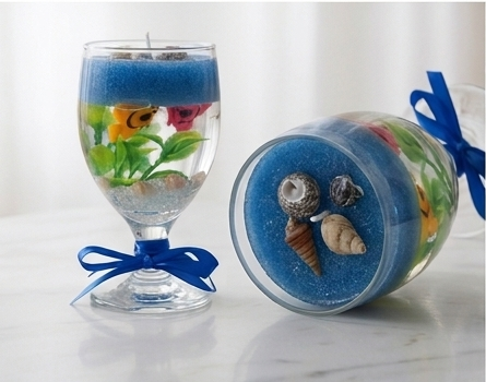 Two Aquarium Gel candles styled together, one upright and one on its side
